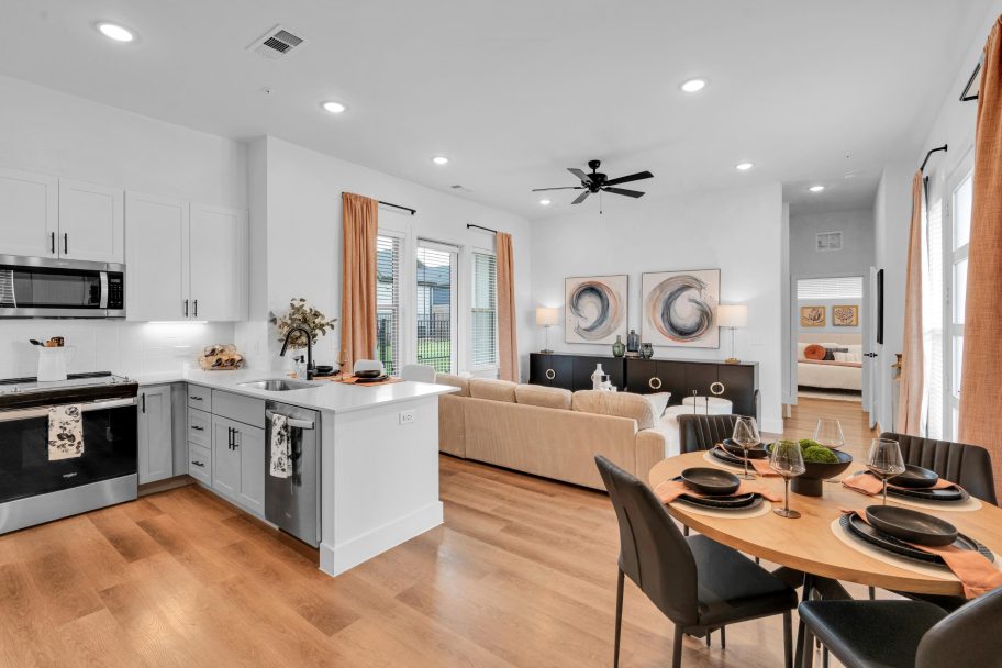 a kitchen and living room with hardwood floors at The parcHAUS at Firewheel Parkway