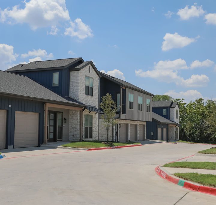 Exterior of The parcHAUS at Firewheel Parkway's residential complex with garages