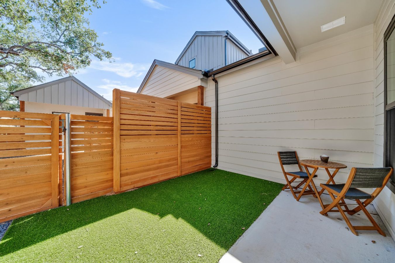 Private home backyard with a wooden fence and grass at parcHAUS at Mustang Drive