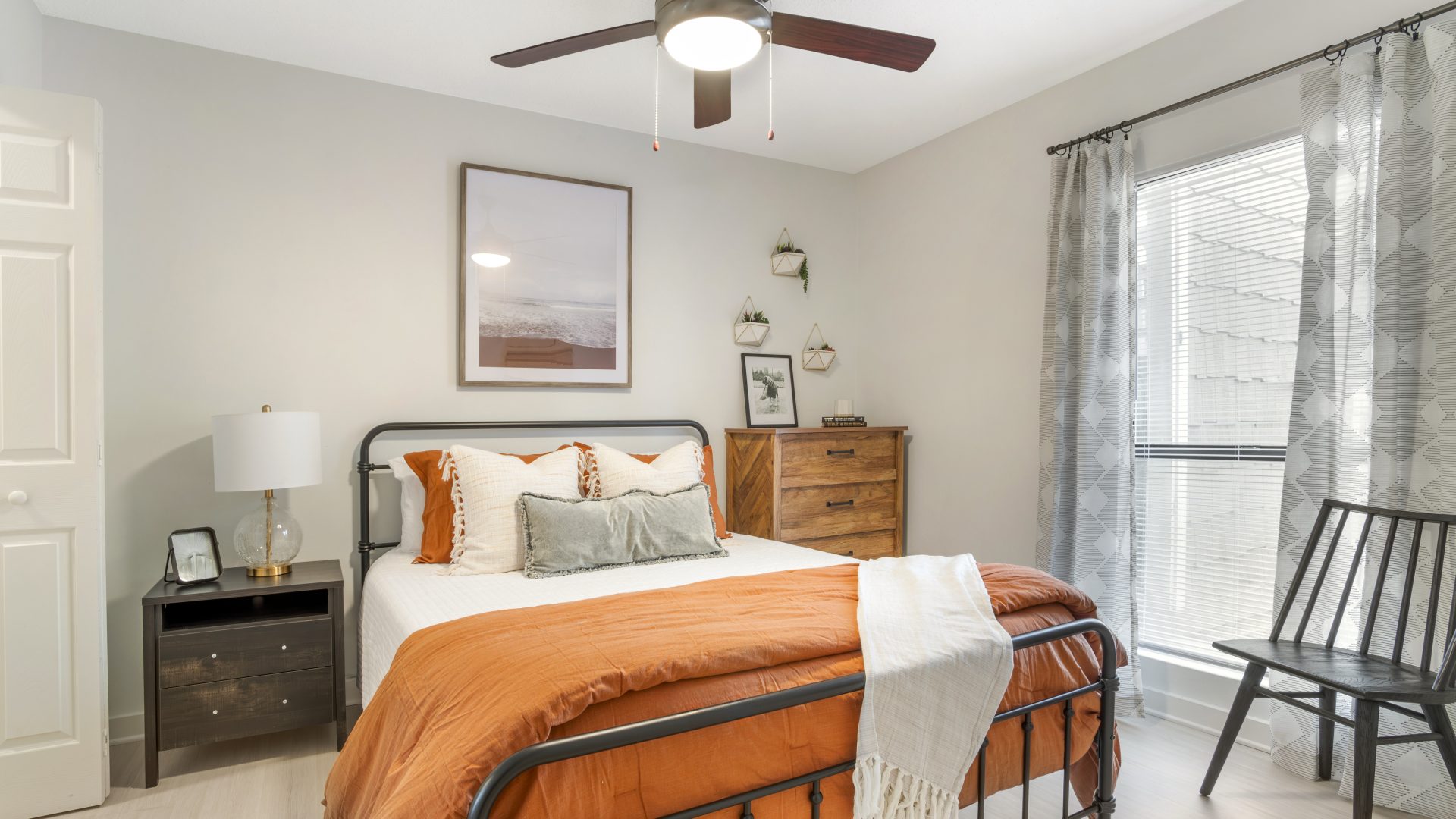 a bedroom with a bed, dresser and ceiling fan at The  Marley