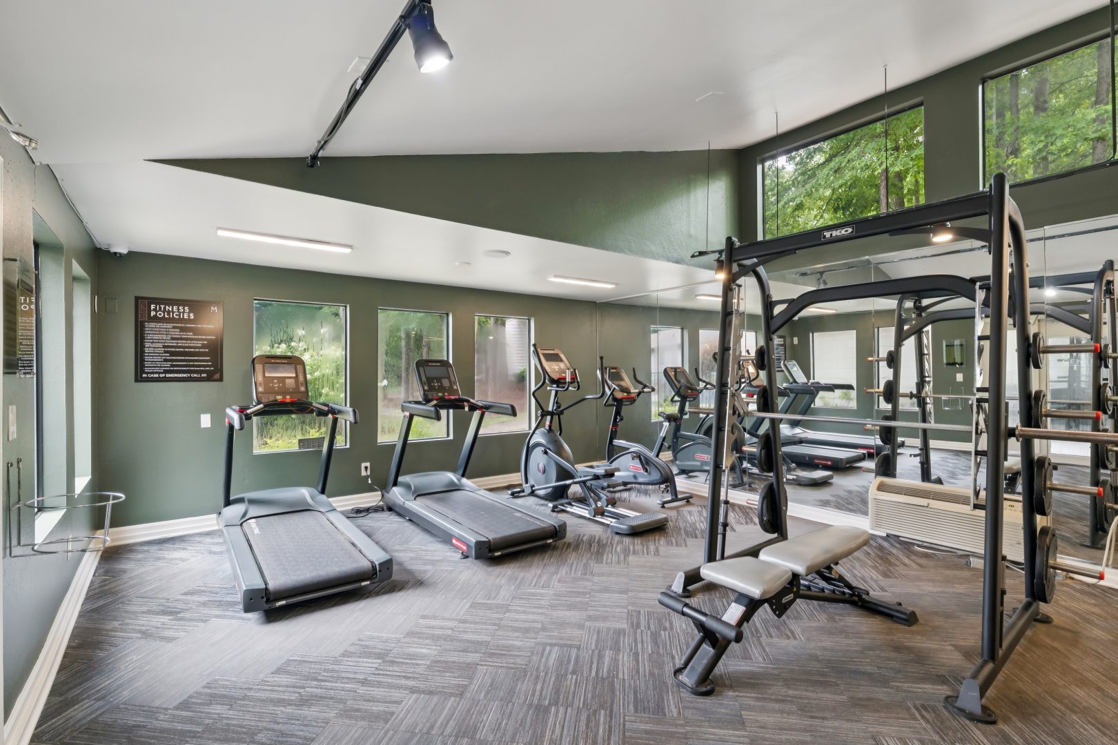 a gym room with tread machines and exercise equipment at The  Marley