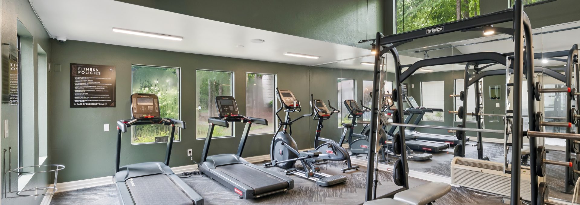 a gym room with tread machines and exercise equipment at The  Marley
