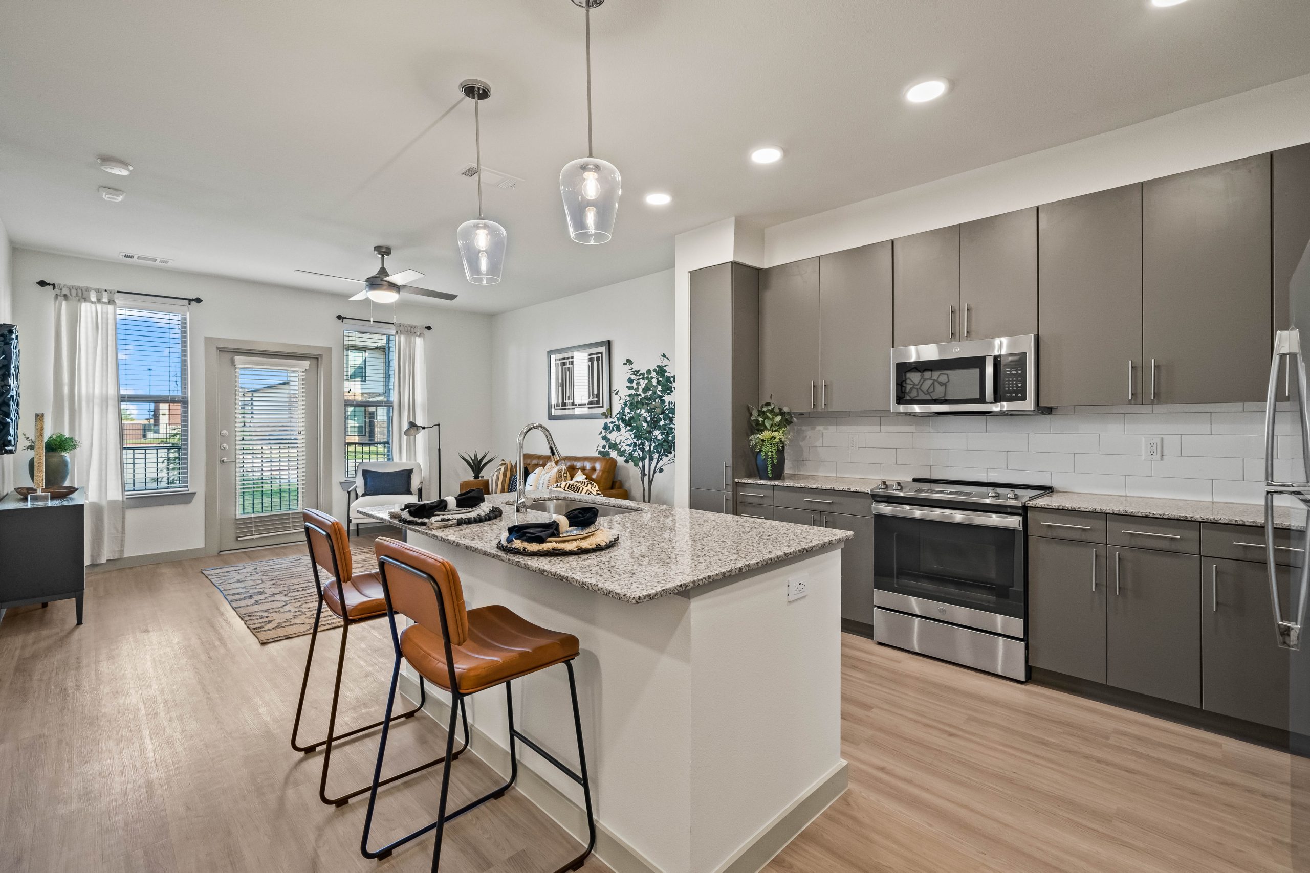 a kitchen with stainless steel appliances and hardwood floors at The La Ventana