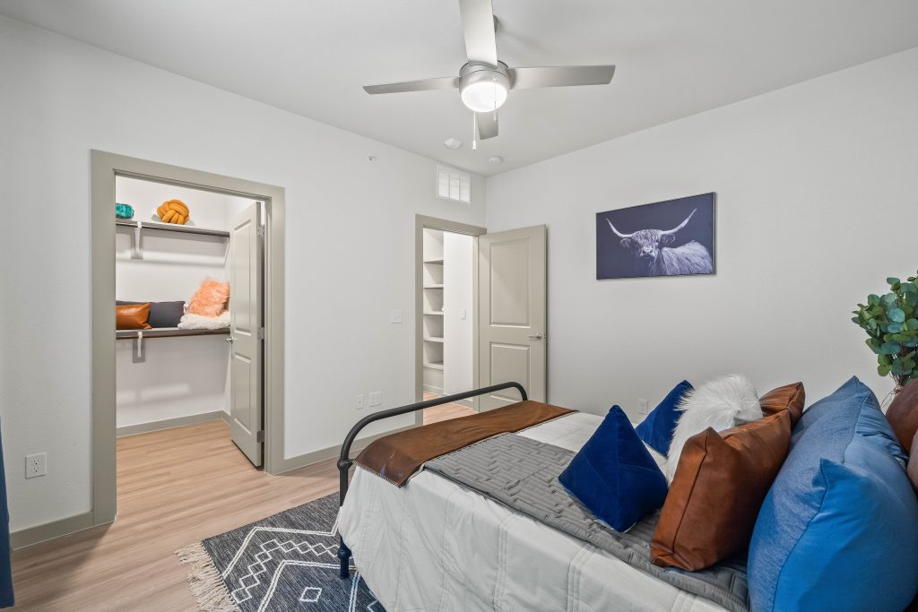 a bedroom with a bed, dresser and ceiling fan at The La Ventana