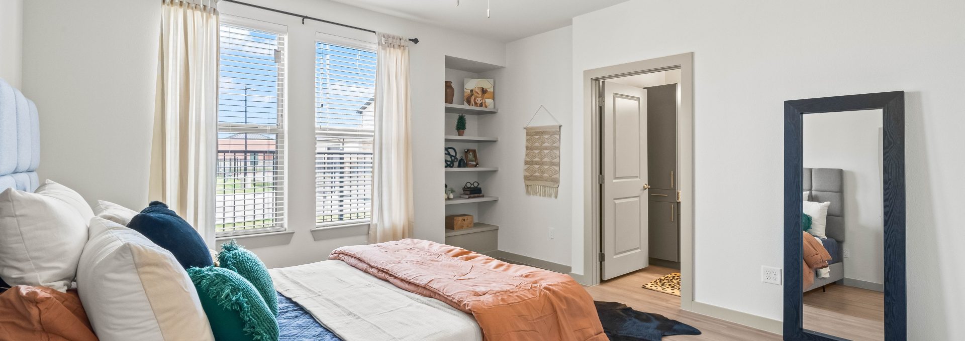 a bedroom with a bed, dresser, and mirror at The La Ventana