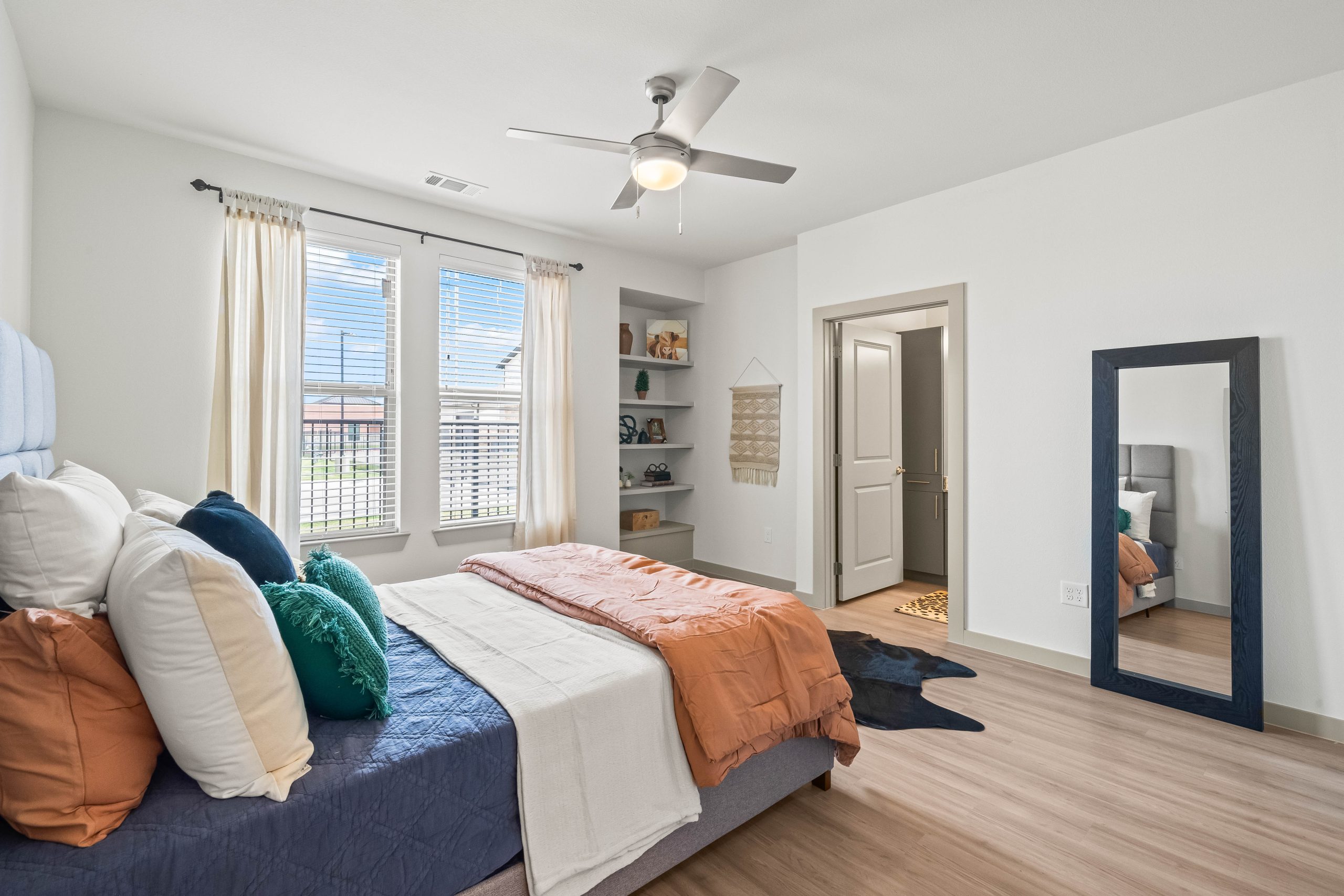 a bedroom with a bed, dresser, and mirror at The La Ventana