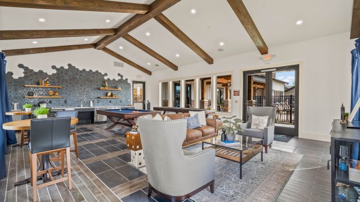 the living room has a wood ceiling and a fireplace at The La Ventana at Canyon West Apartments