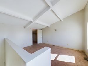 an empty room with white walls and ceiling at The Beacon Hill Apartments