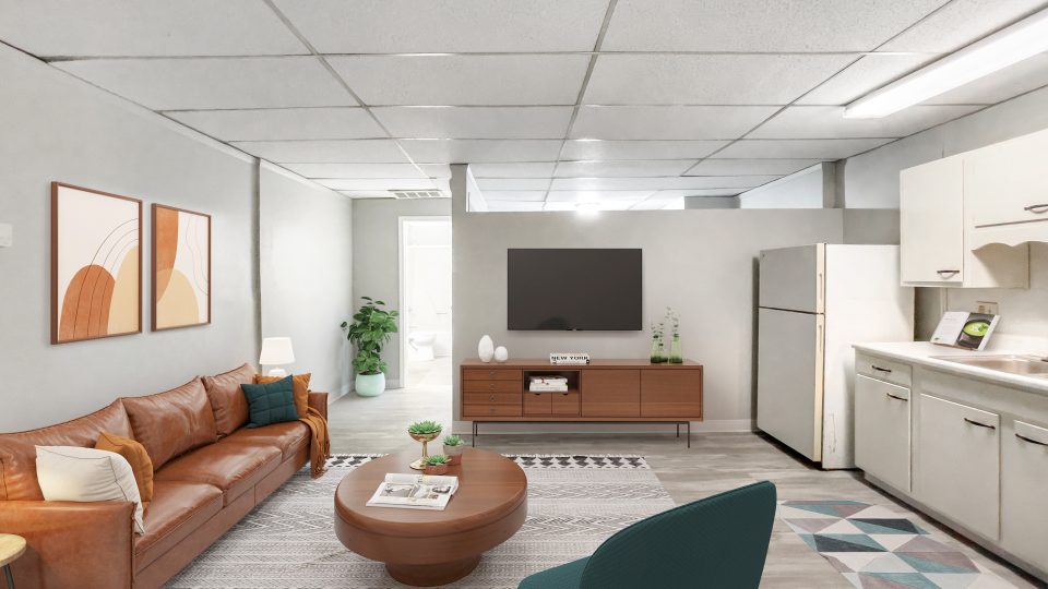 a rendering of a living room with a couch, coffee table and television at The Beacon Hill Apartments