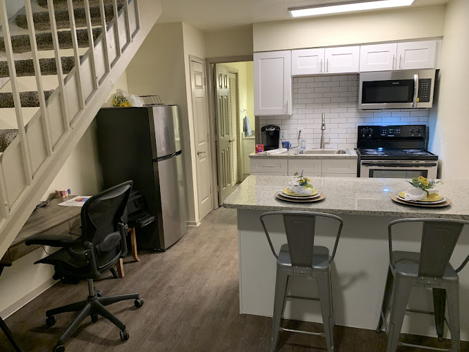a kitchen with a stove, refrigerator and counter top at The Kings Lofts