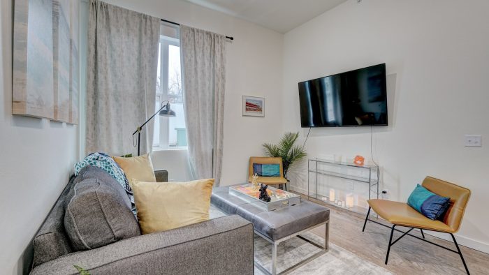 a living room with a couch, television and coffee table at The  Campbell