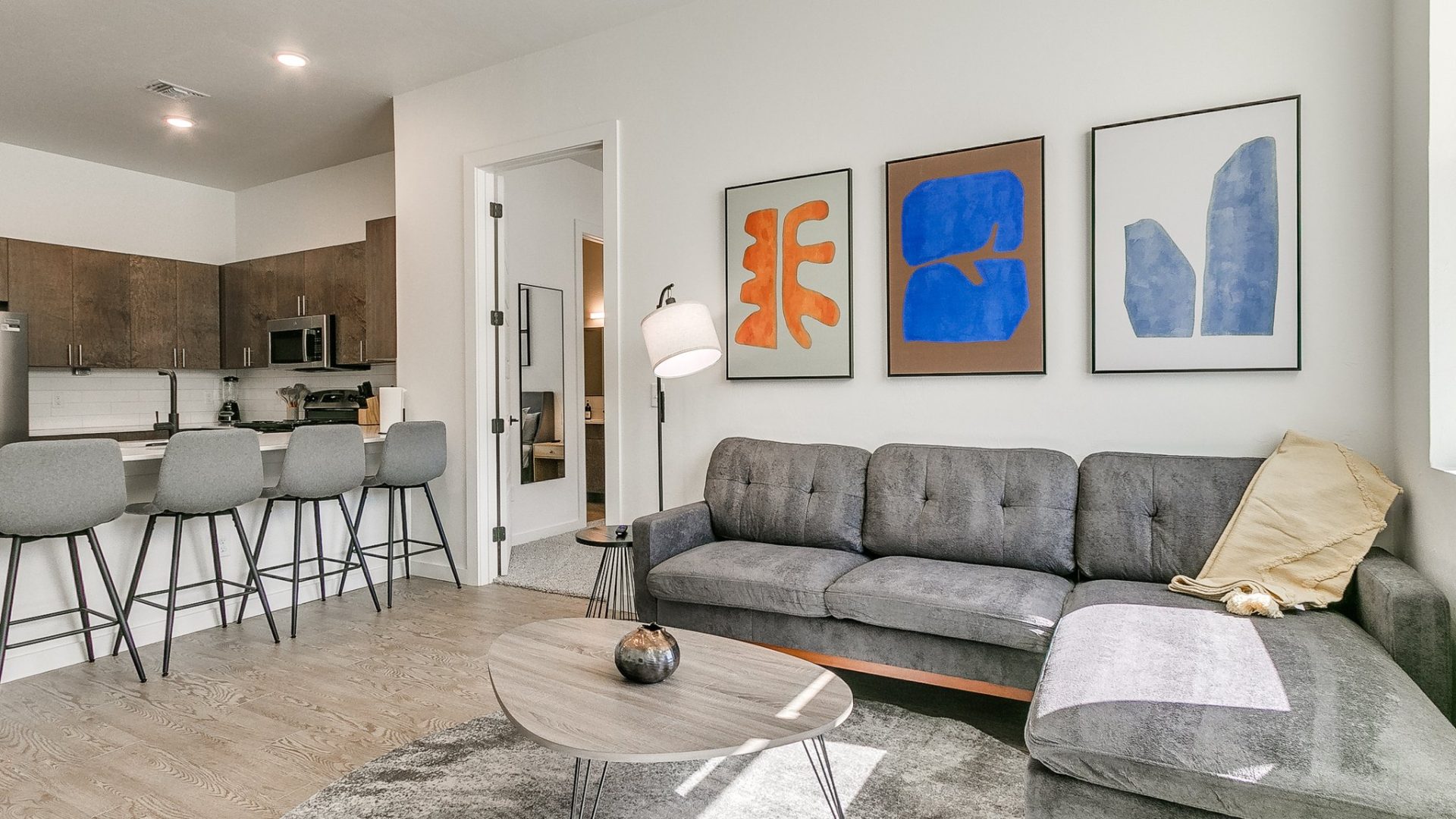 a living room with a couch, coffee table and chairs at The  Campbell
