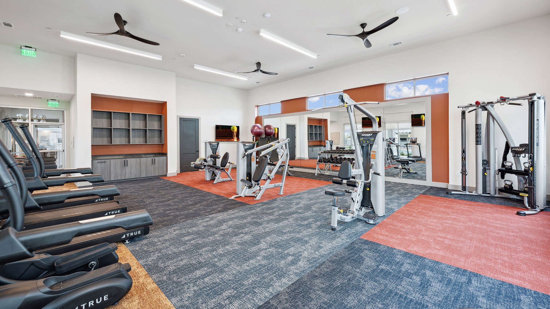 a gym room with exercise equipment and a ceiling fan at The Legacy at Veramendi