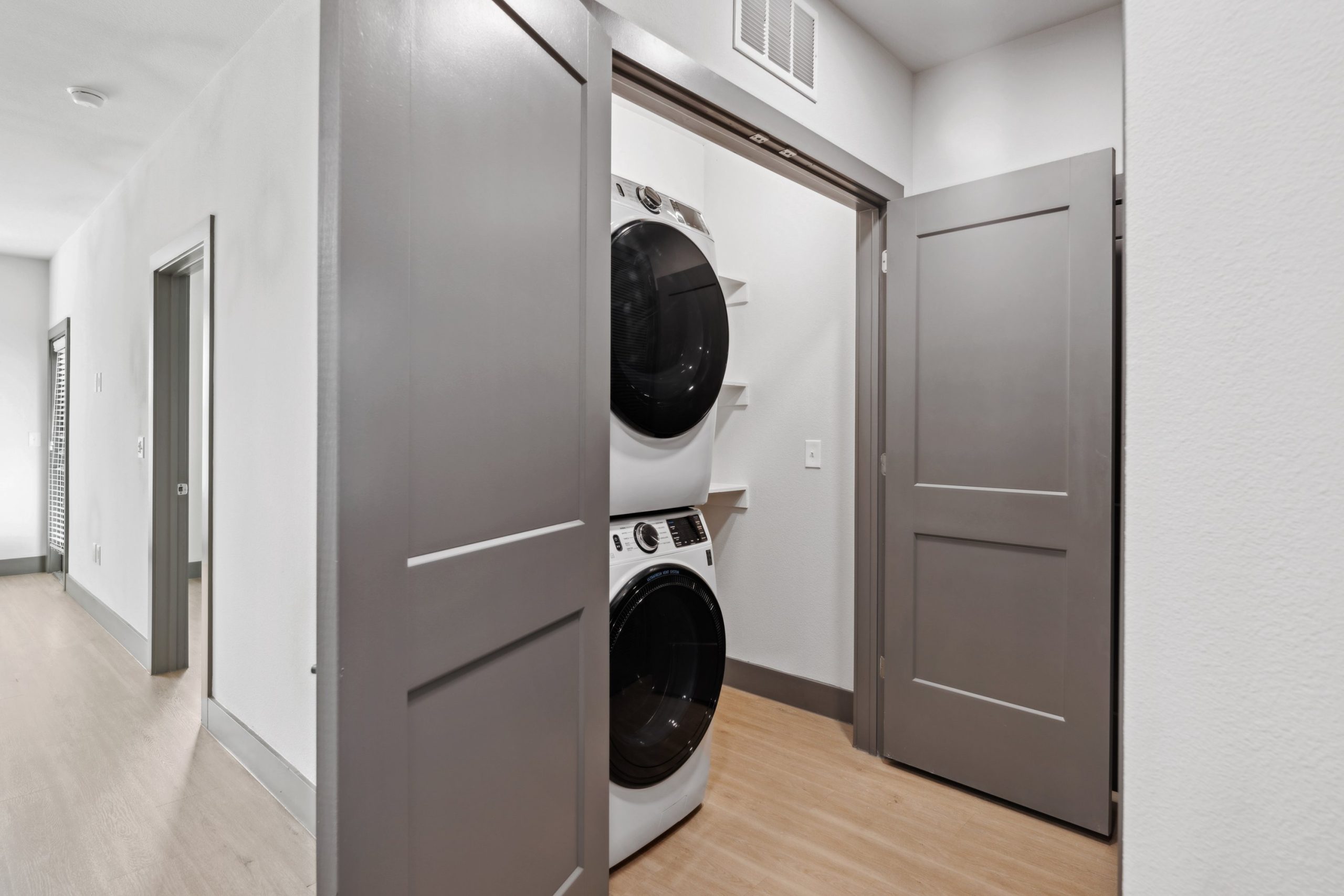 a laundry room with a washer and dryer in it at The Legacy at Veramendi