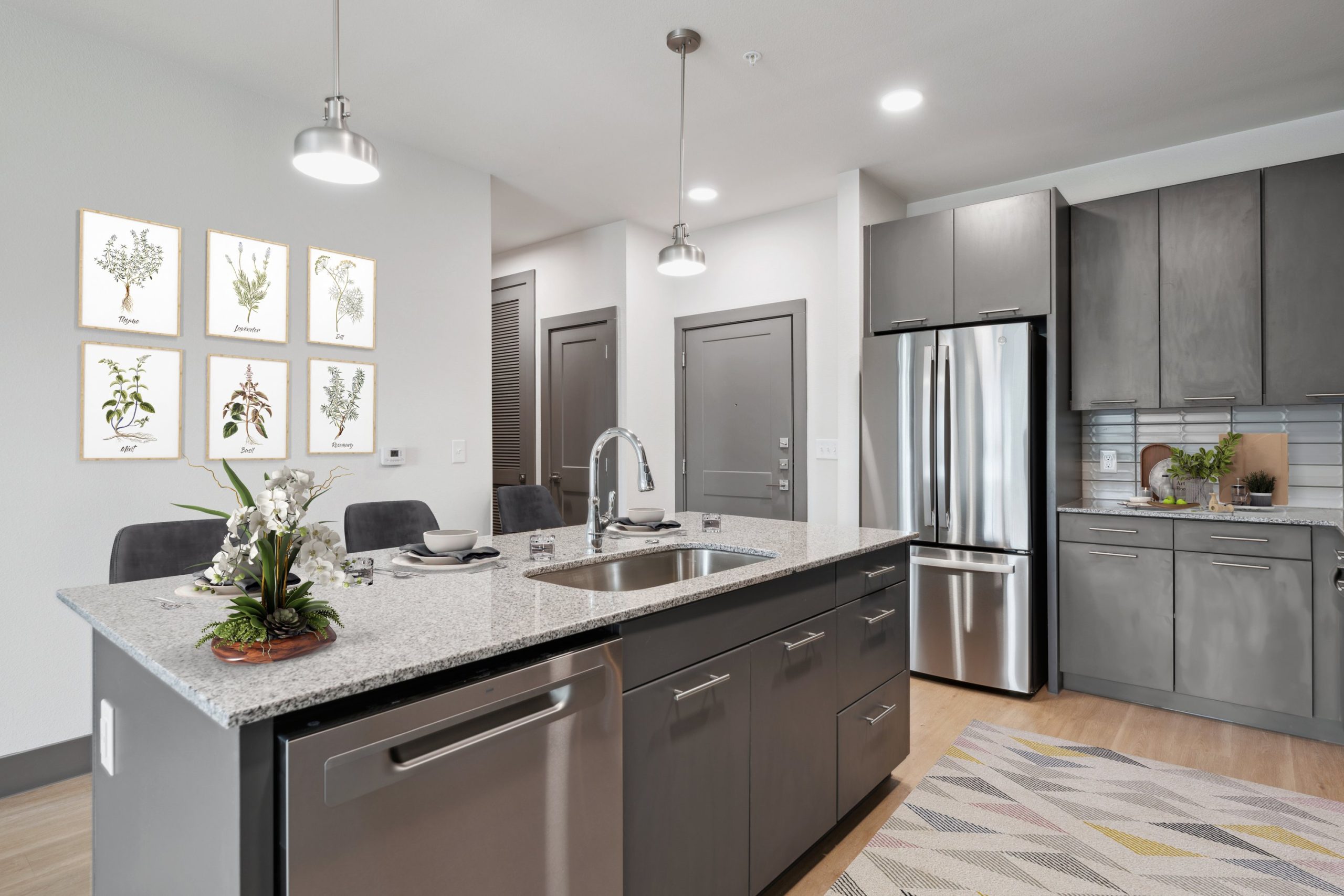 a kitchen with stainless steel appliances and a gray counter top at The Legacy at Veramendi