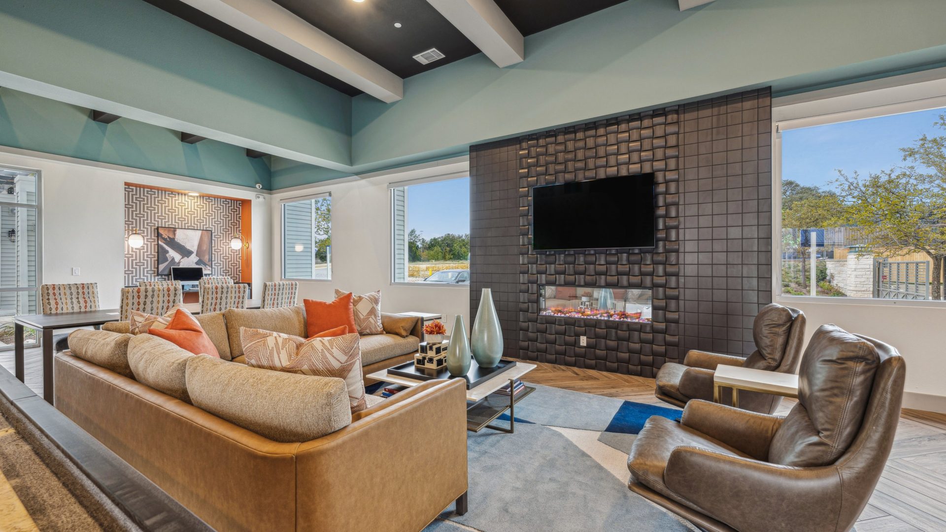 the living room features a large flat screen tv and a fireplace at The Legacy at Veramendi