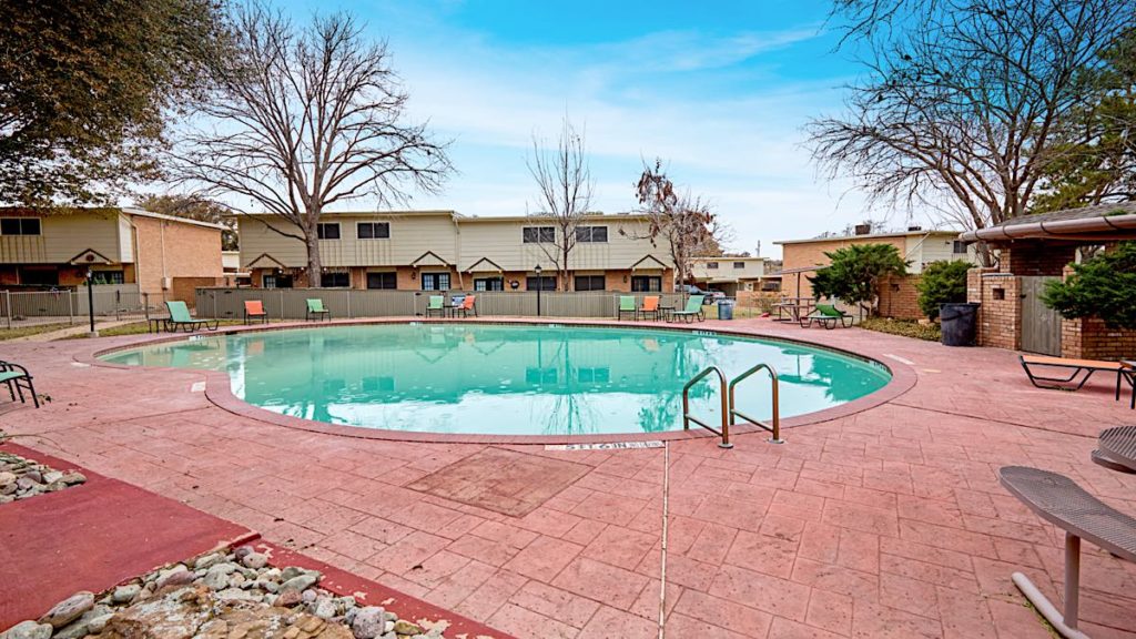 a pool in a residential area with a patio at The Cielo Vista