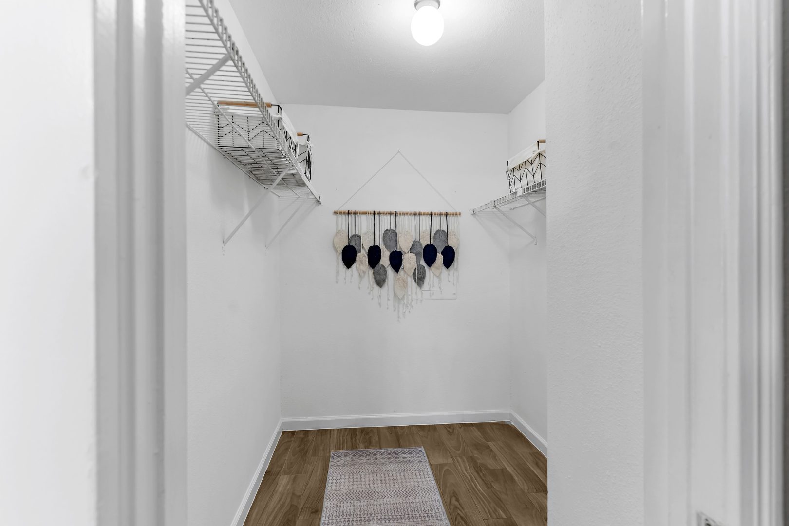 a closet with clothes hanging on the wall at The Sonoma Apartments