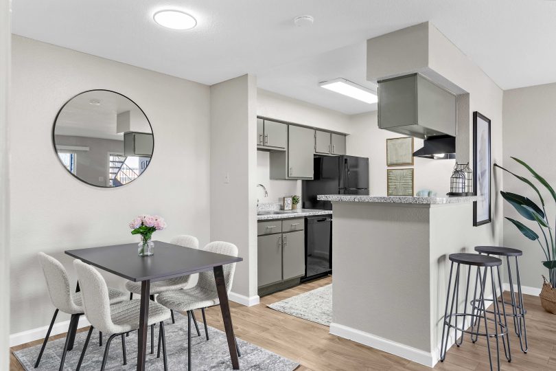 a kitchen and dining area in a small apartment at The Sonoma Apartments