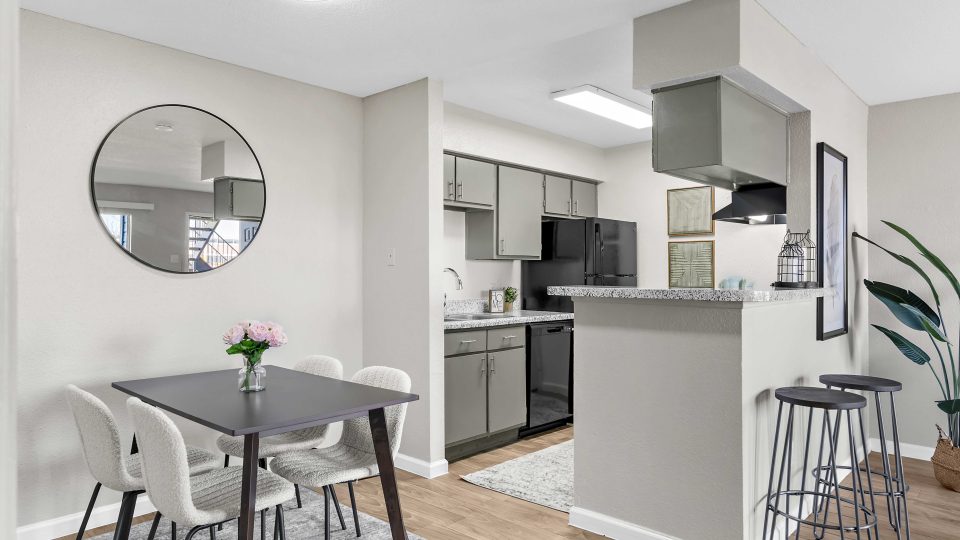 a kitchen and dining area in a small apartment at The Sonoma Apartments