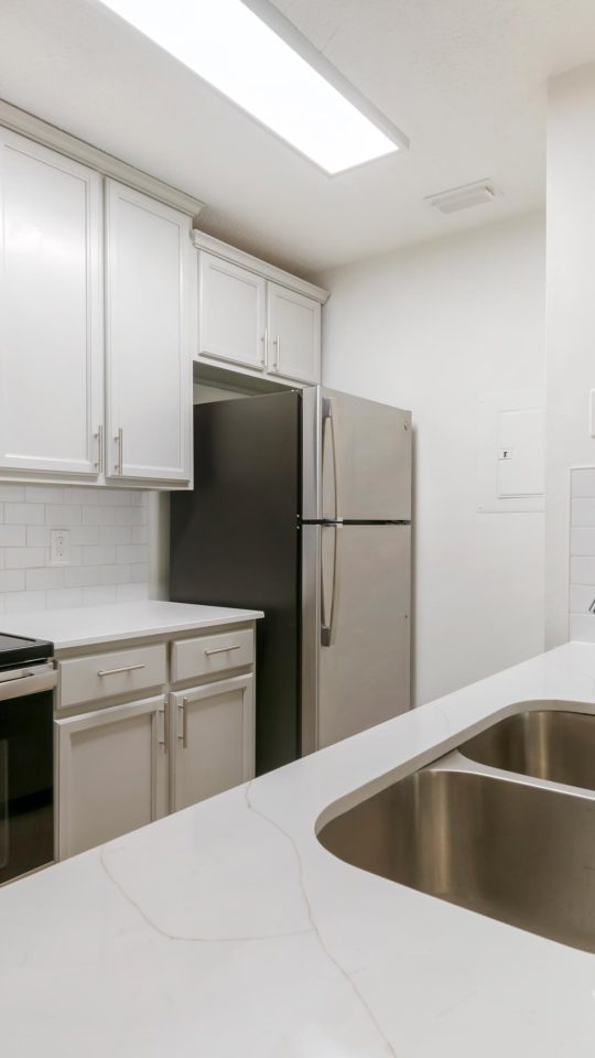 a kitchen with stainless steel appliances and a sink at The Vista Bay