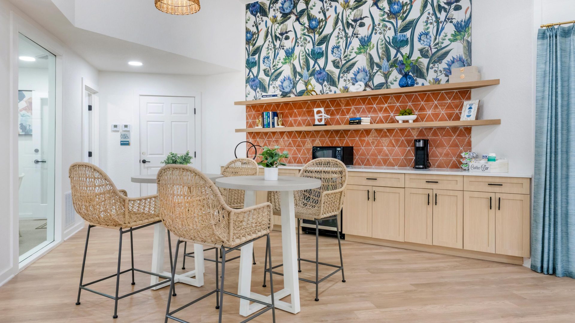 a kitchen with a large table and chairs and a wall with a colorful mural at The Vista Bay