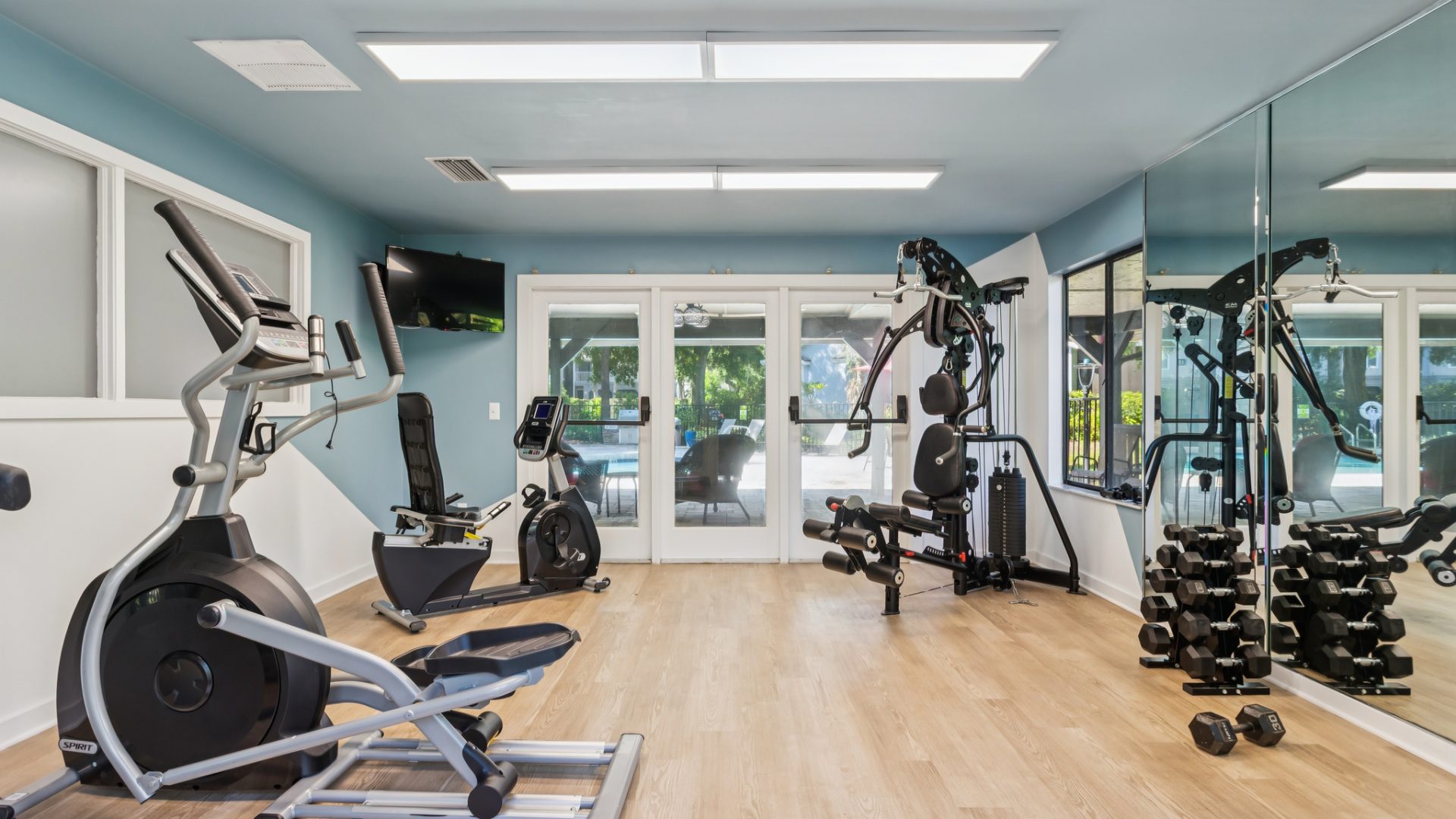 a gym room with exercise equipment and mirrors at The Vista Bay