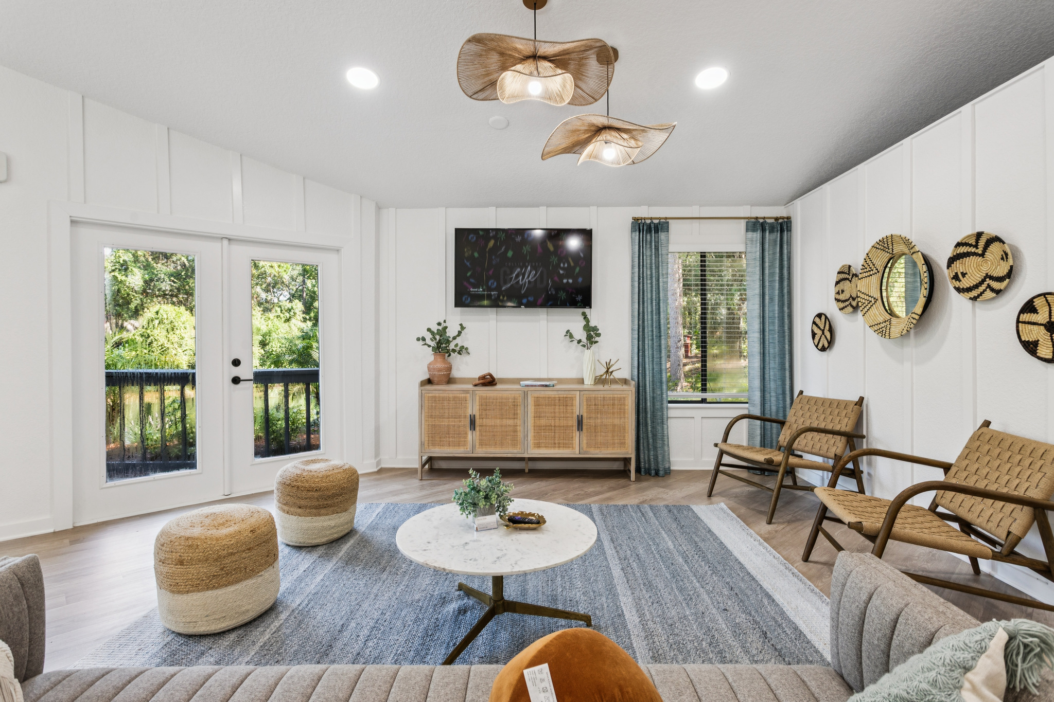 a living room with a ceiling fan and a couch at The Vista Bay