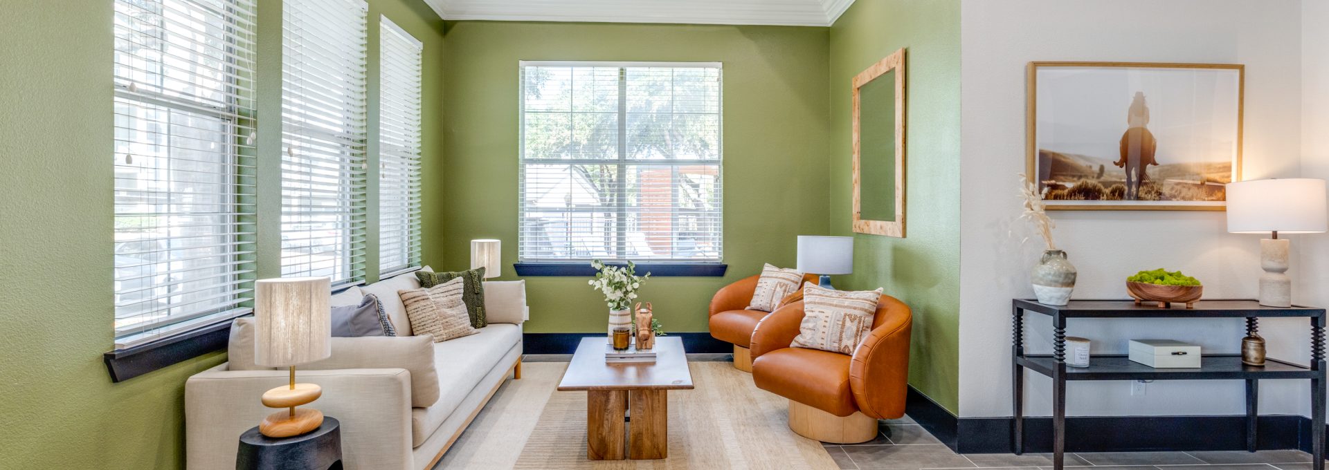 a living room with green walls and white furniture at The Stetson