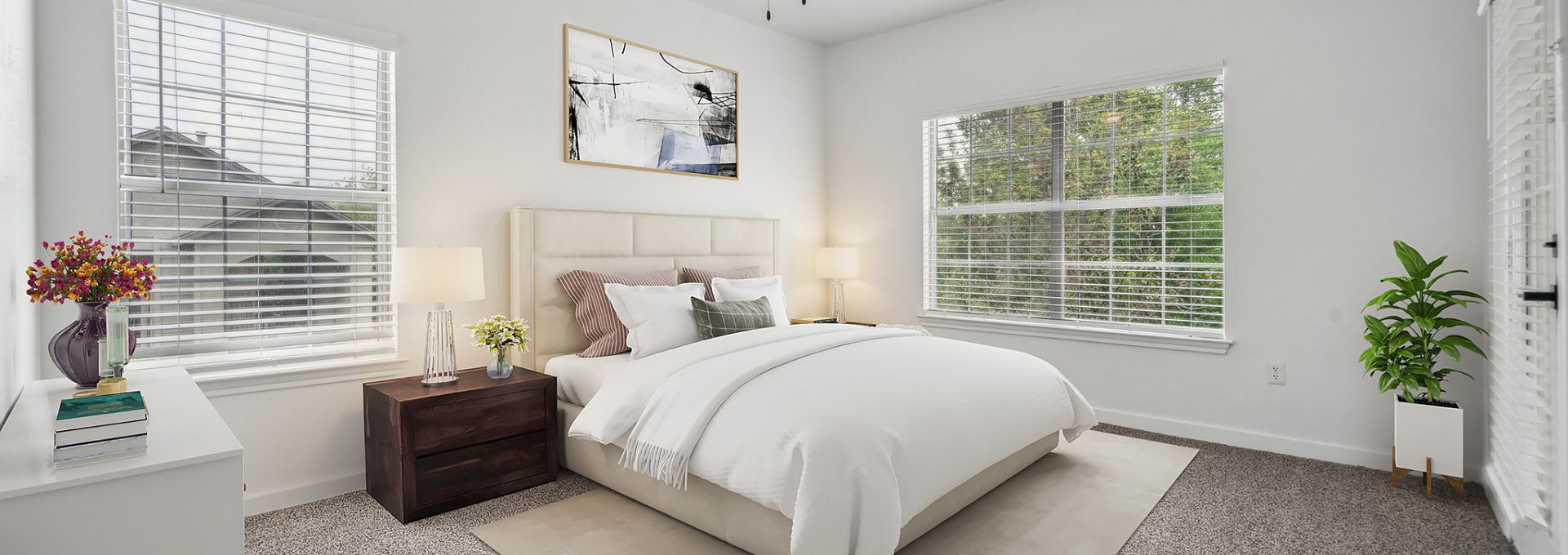 a bedroom with a ceiling fan and white walls at The Stetson