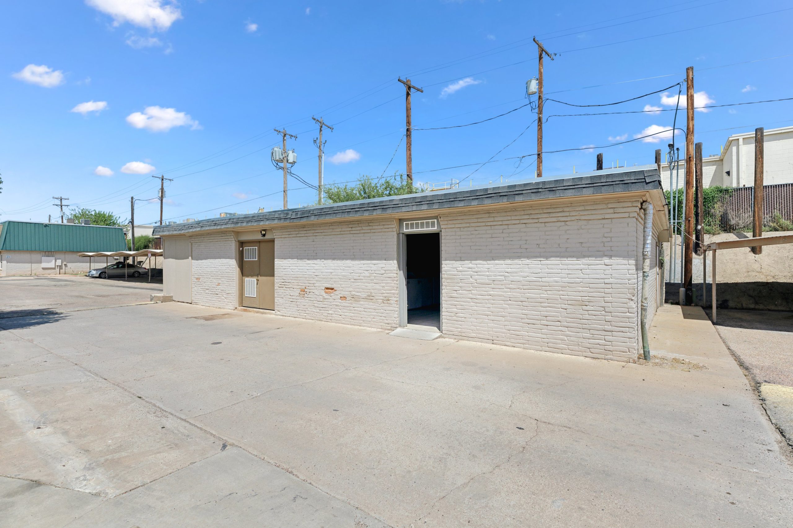 a small building with a parking lot and a street at The Crestwood Terrace