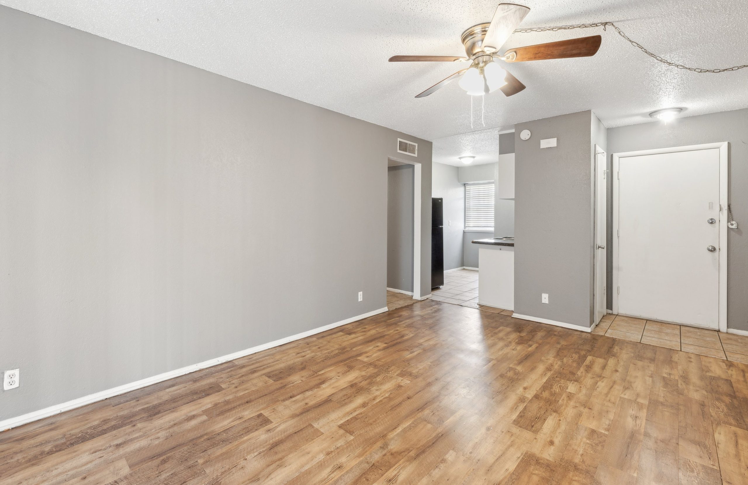 empty room with hardwood floors and ceiling fan at The Crestwood Terrace