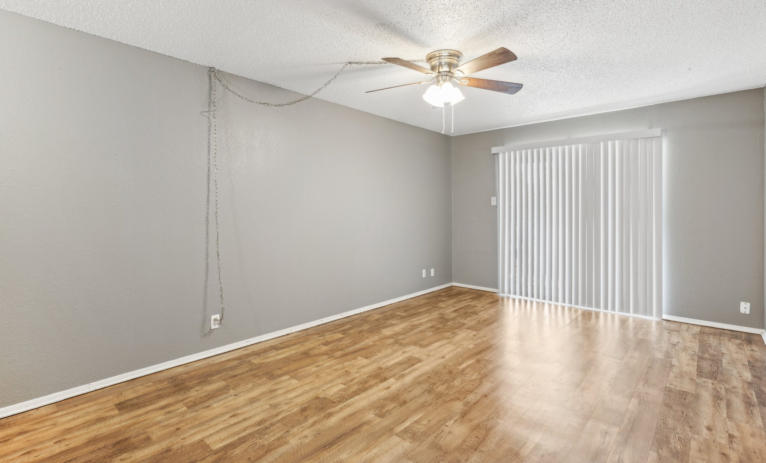 empty room with hardwood floors and ceiling fan at The Crestwood Terrace