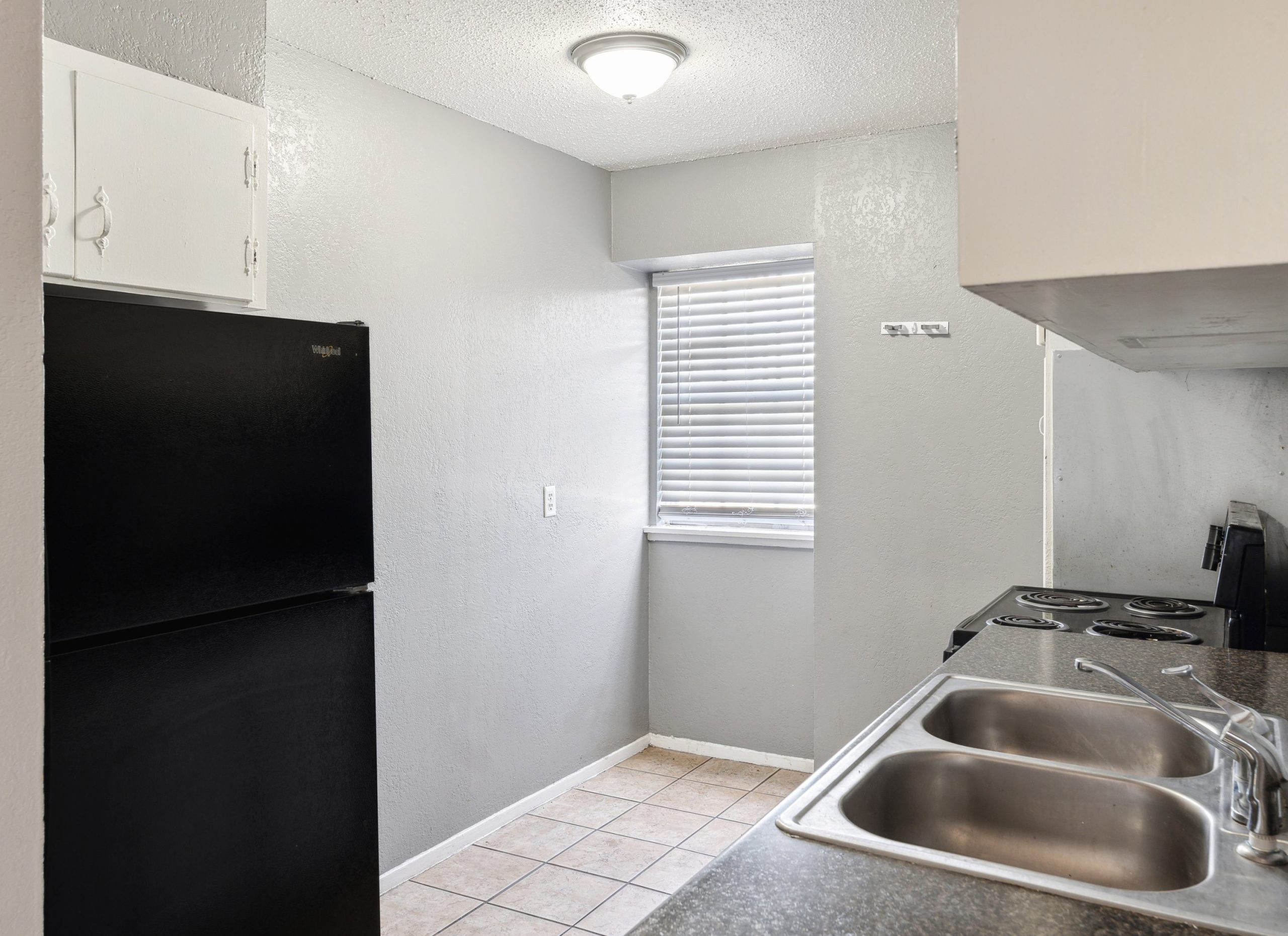 a kitchen with black appliances and a window at The Crestwood Terrace