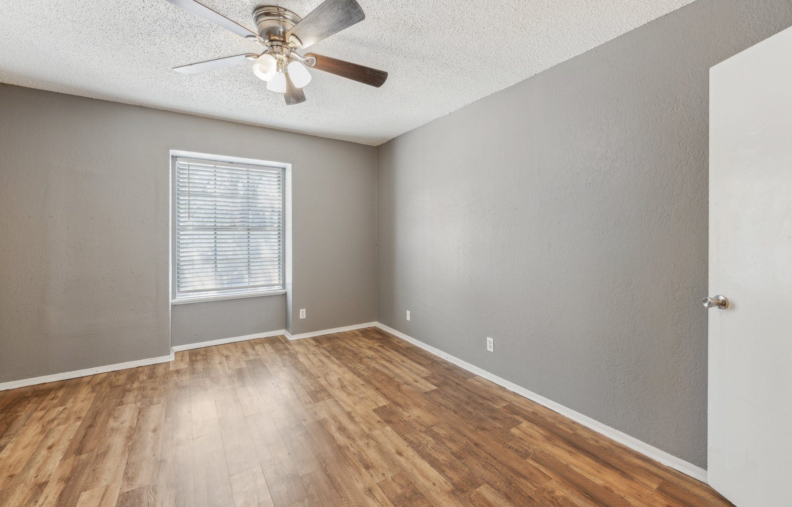 empty room with hardwood floors and ceiling fan at The Crestwood Terrace