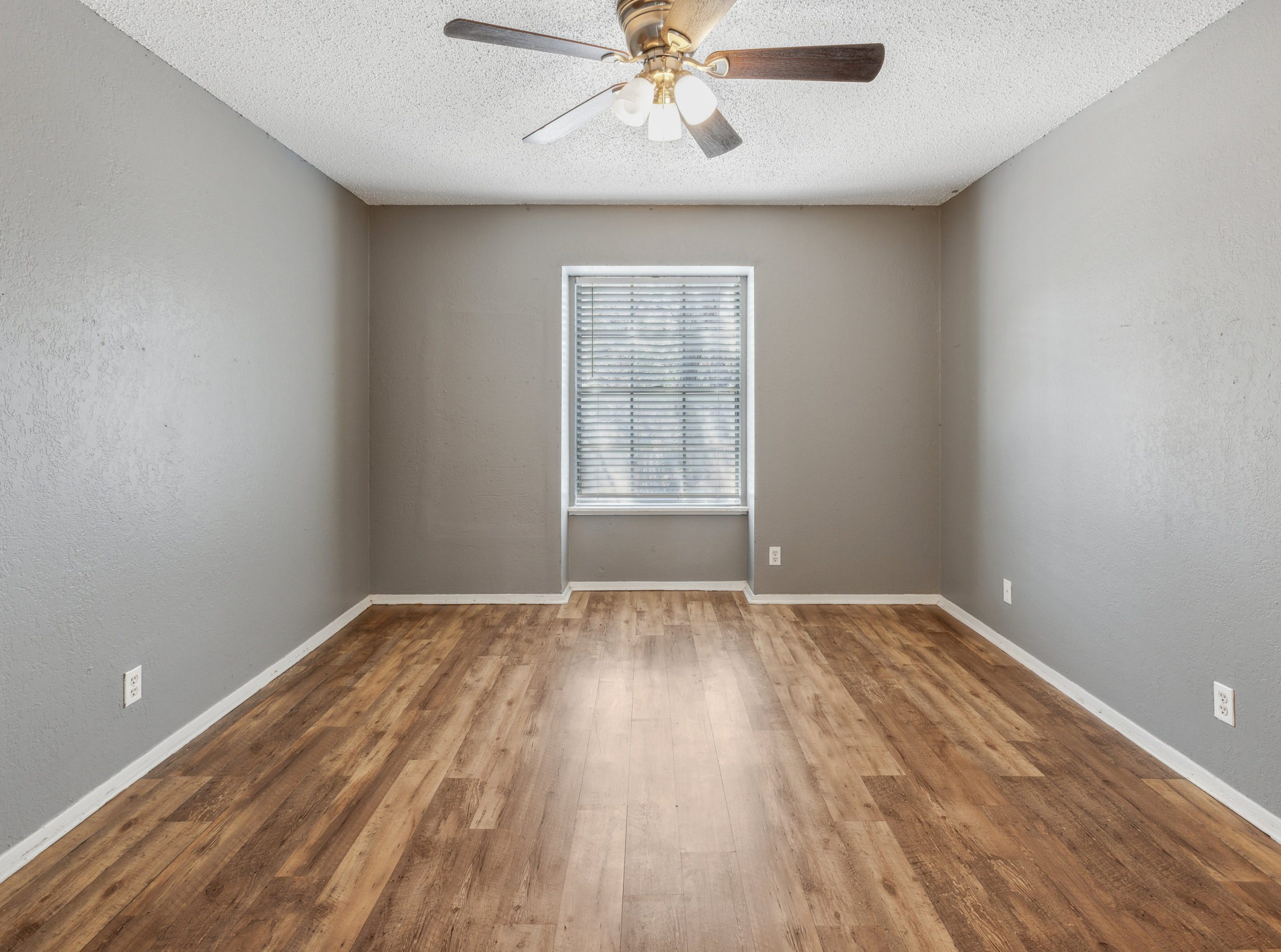 empty room with ceiling fan and hardwood floors at The Crestwood Terrace