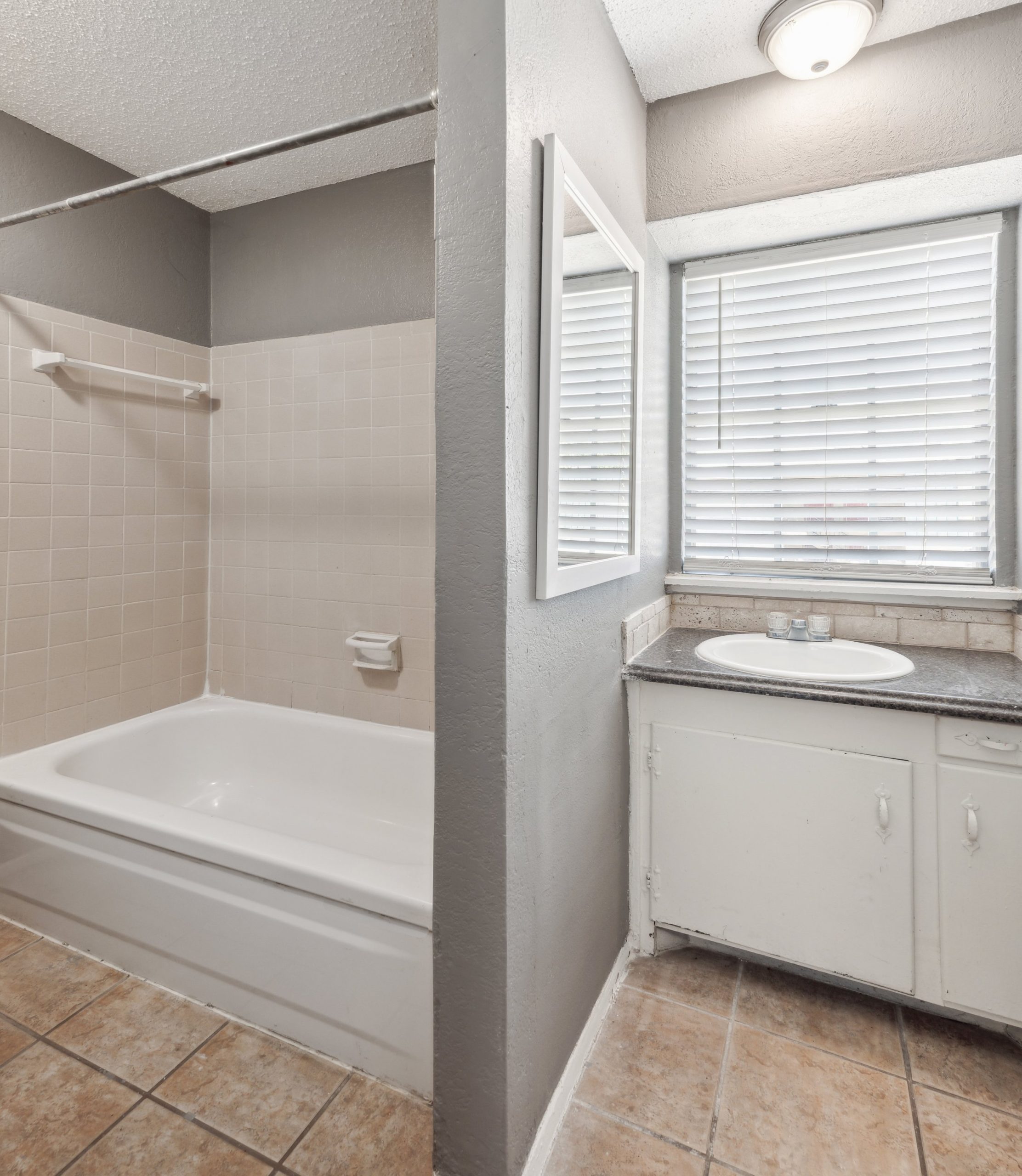 a bathroom with a tub and a sink in it at The Crestwood Terrace