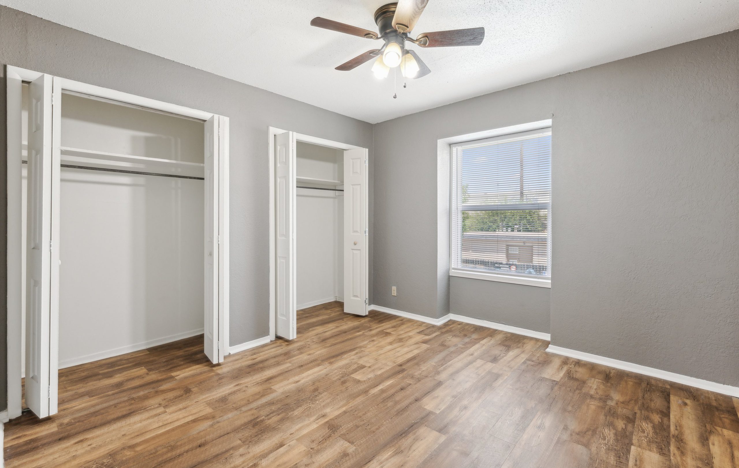 empty room with hardwood floors and ceiling fan at The Crestwood Terrace