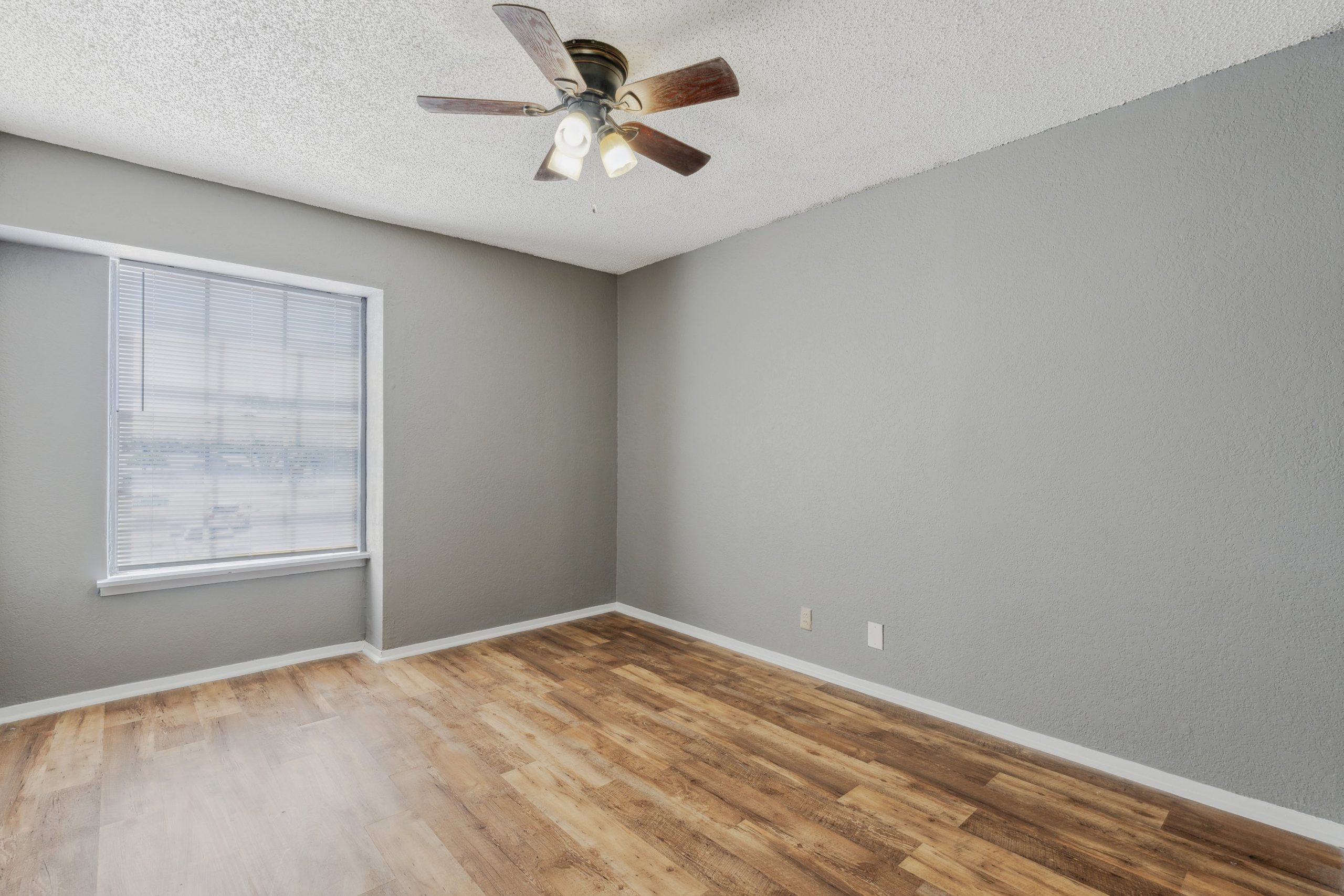 empty room with ceiling fan and hardwood floor at The Crestwood Terrace