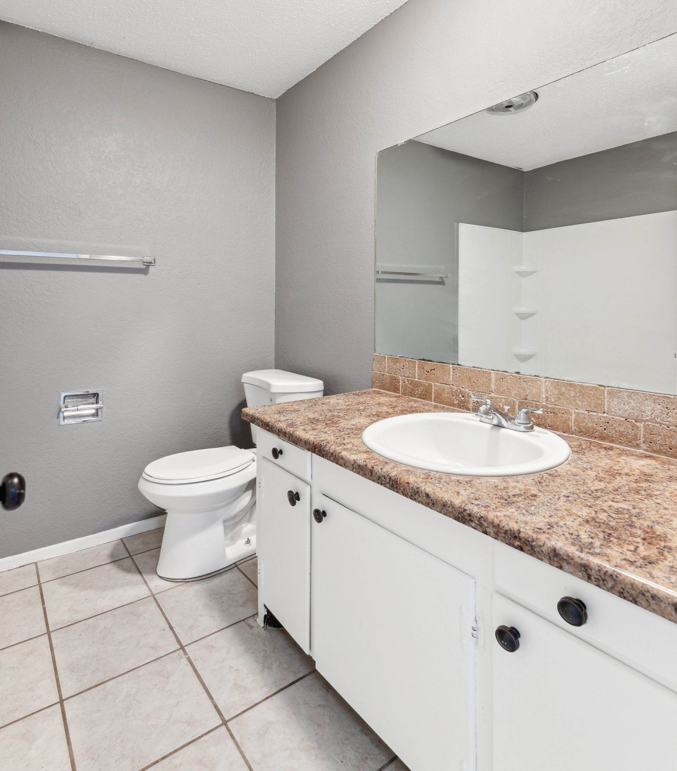 a bathroom with a sink, toilet and mirror at The Crestwood Terrace
