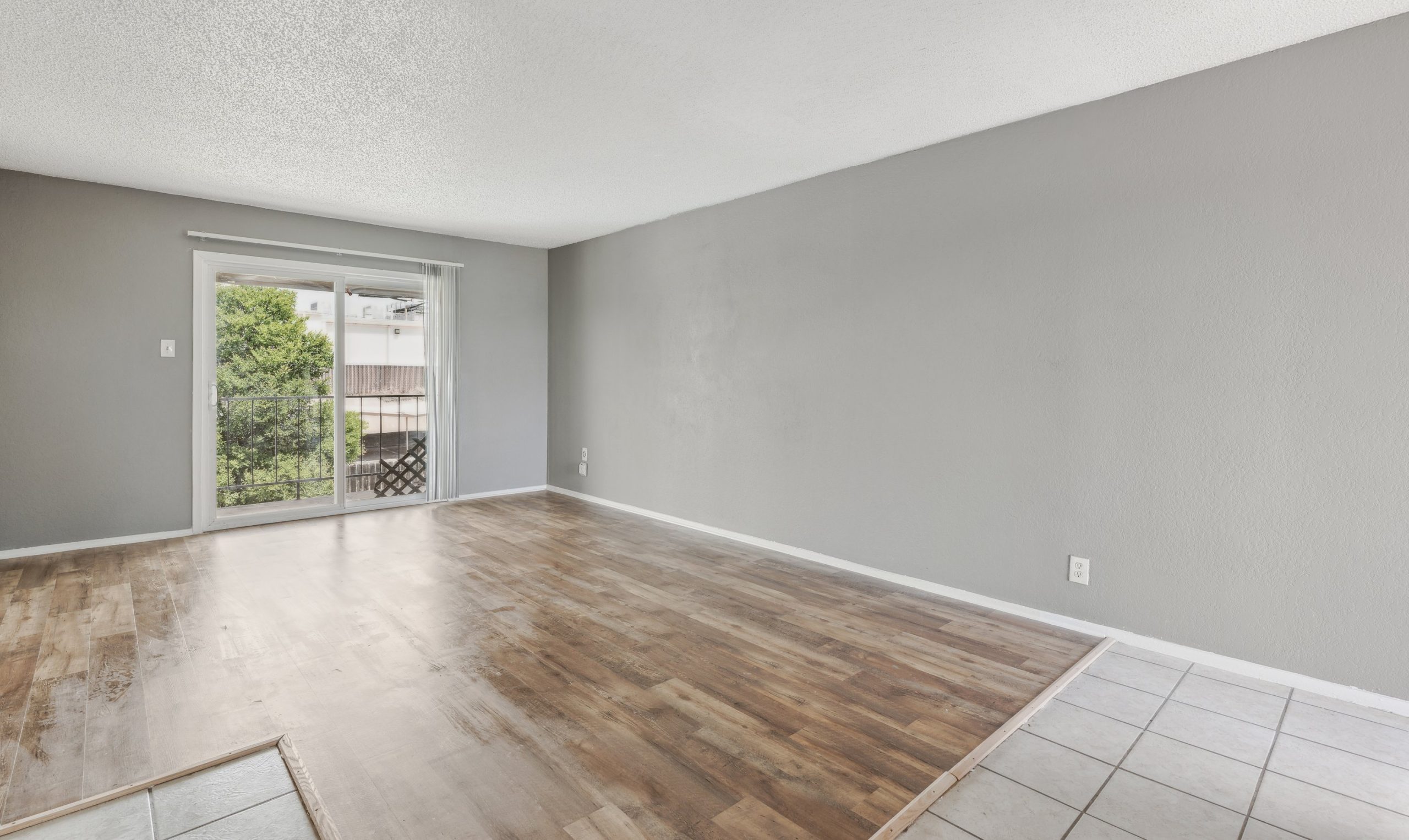 empty room with hardwood floors and sliding glass doors at The Crestwood Terrace