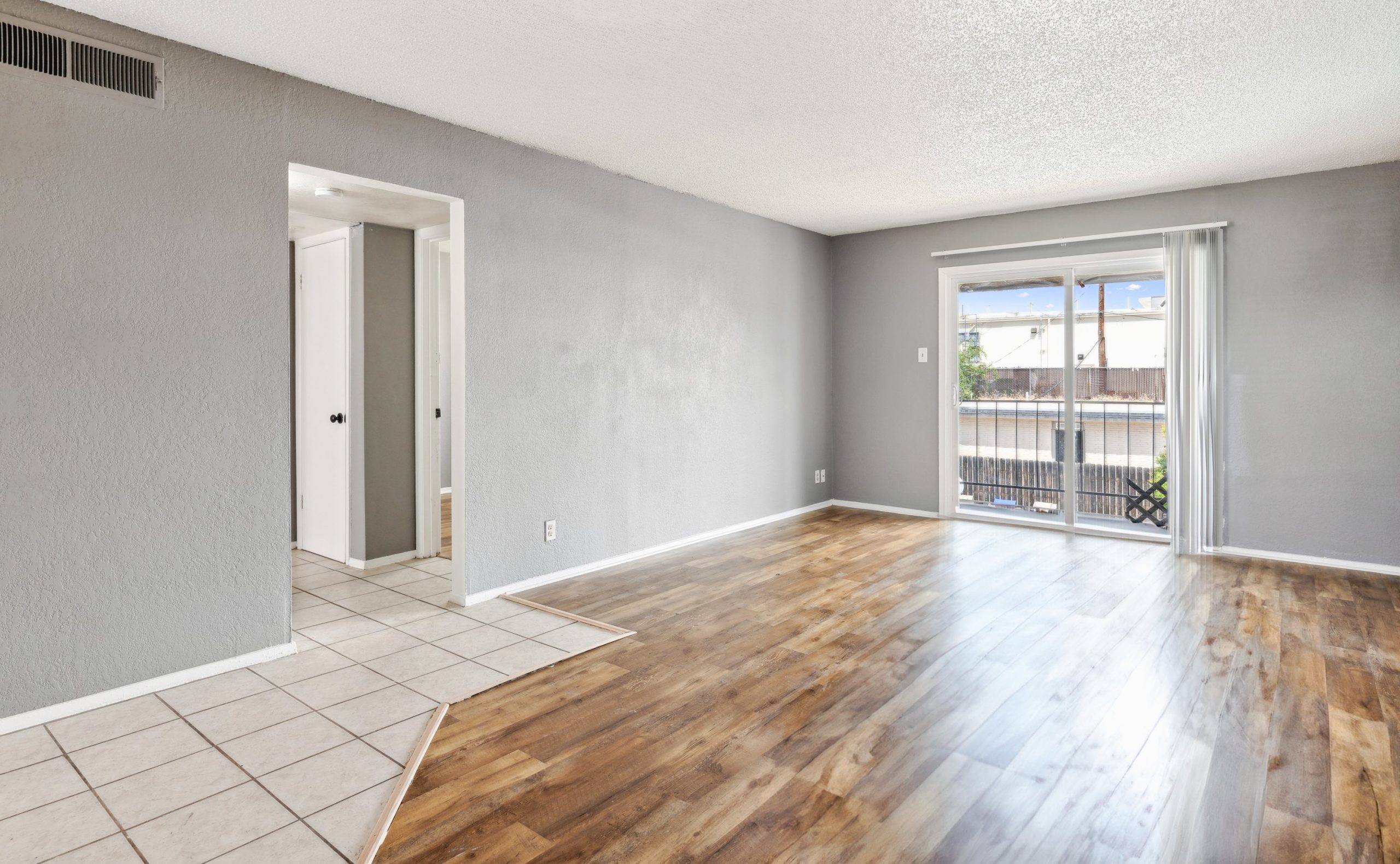an empty room with hardwood floors and a sliding door at The Crestwood Terrace