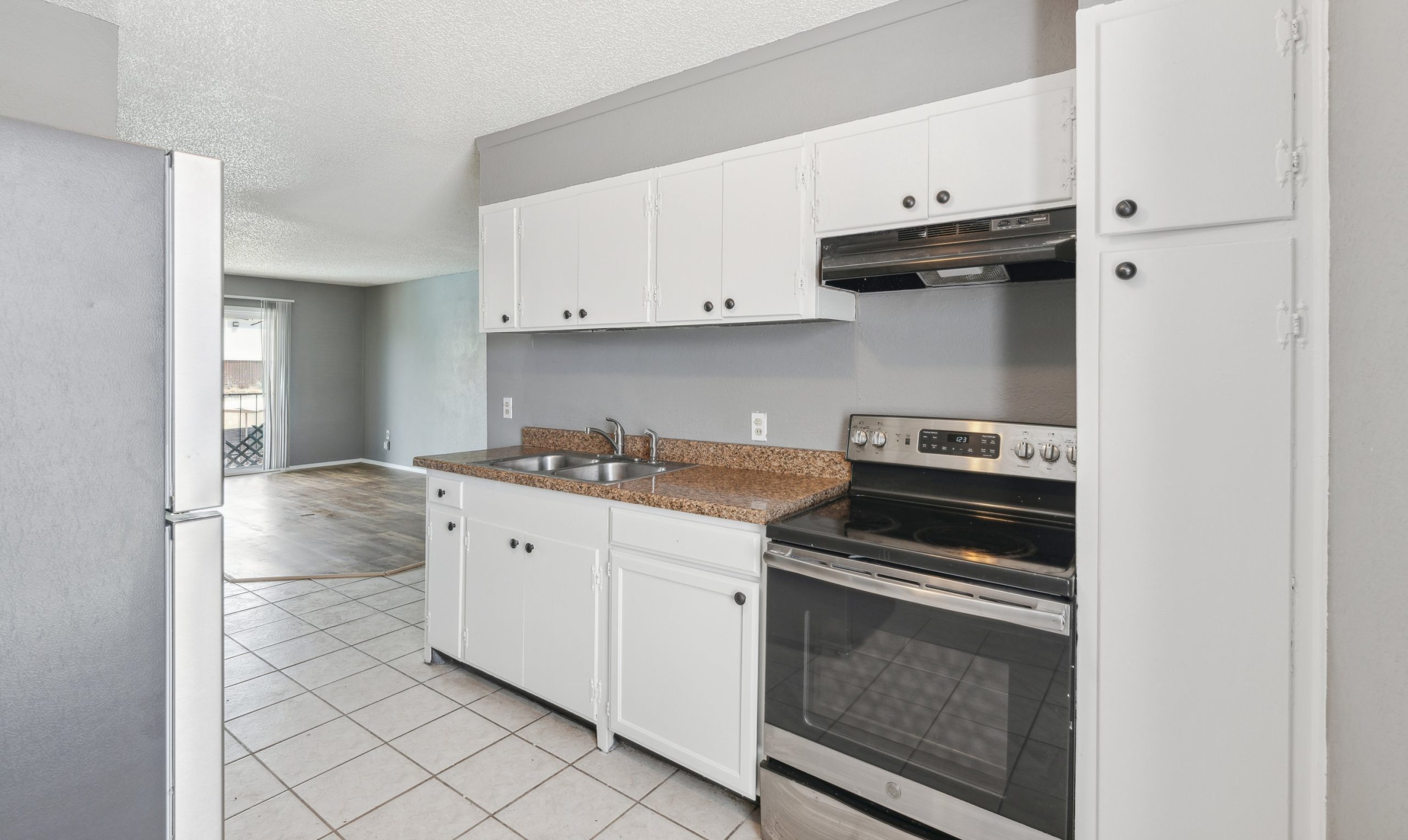 a kitchen with white cabinets and stainless steel appliances at The Crestwood Terrace