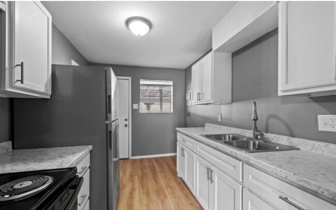 a black and white photo of a kitchen at The Arden Arms Apartments