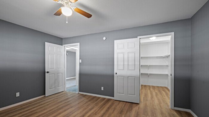 empty room with hardwood floors and ceiling fan at The Arden Arms Apartments