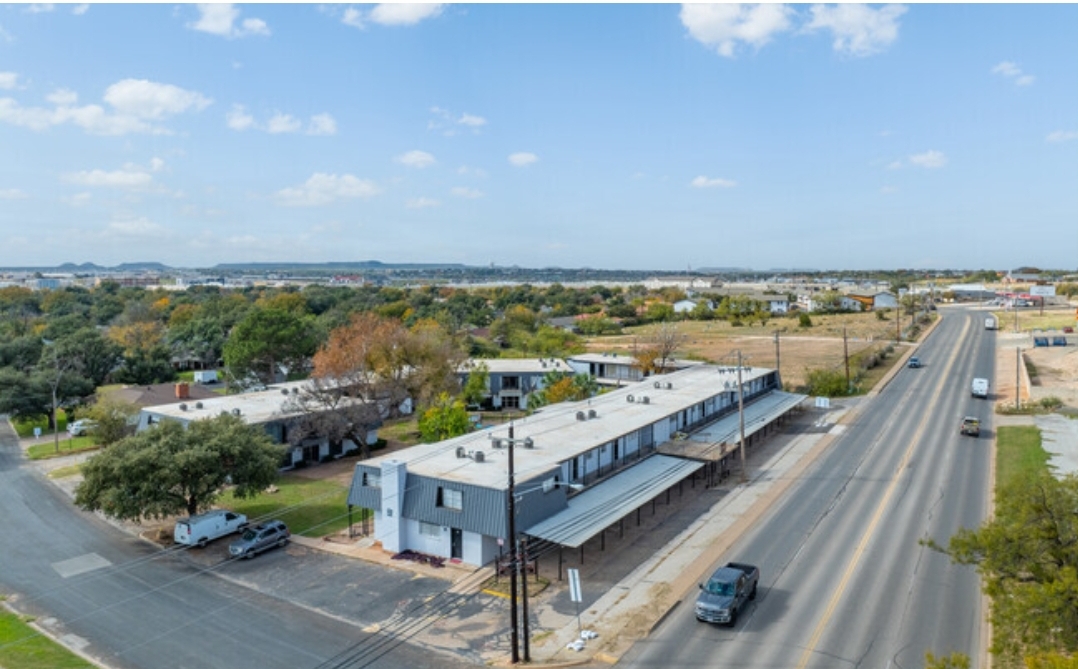 an aerial view of a street with cars and buildings at The Arden Arms Apartments