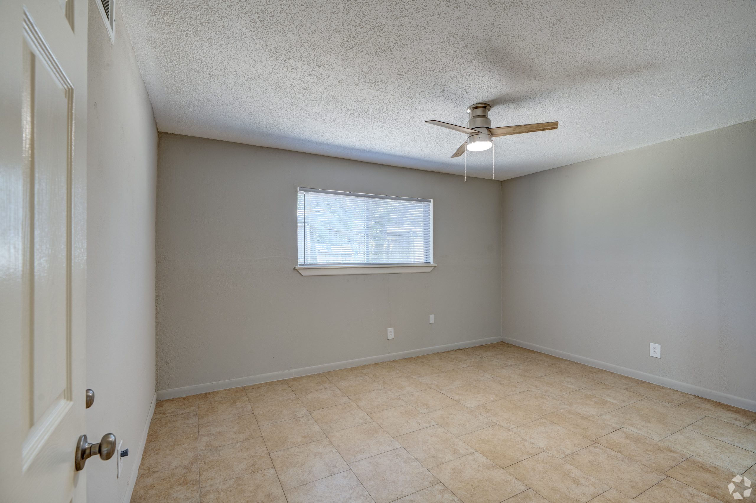 empty room with ceiling fan and tile floor at The Westview Pines