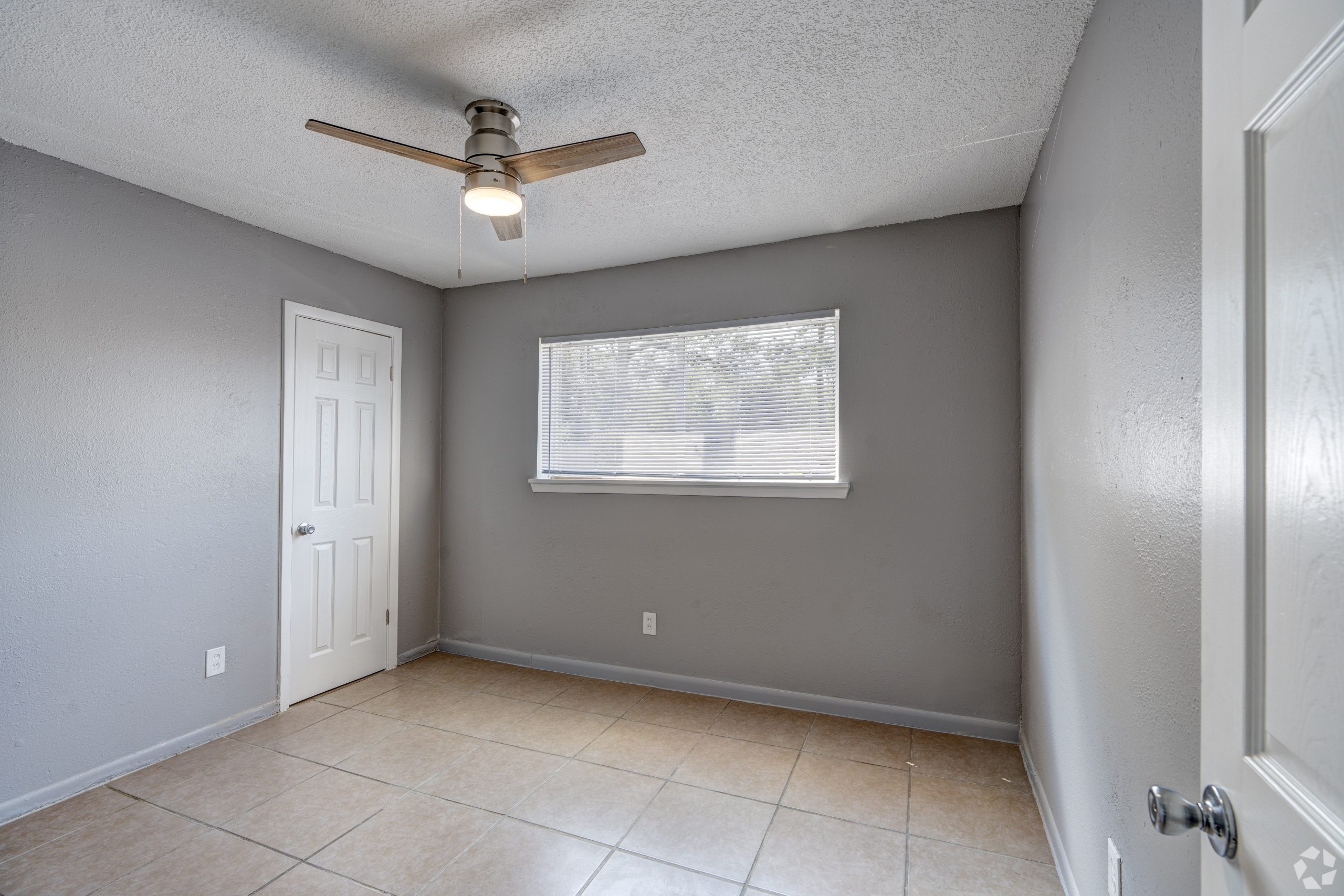 empty room with ceiling fan and tile floor at The Westview Pines