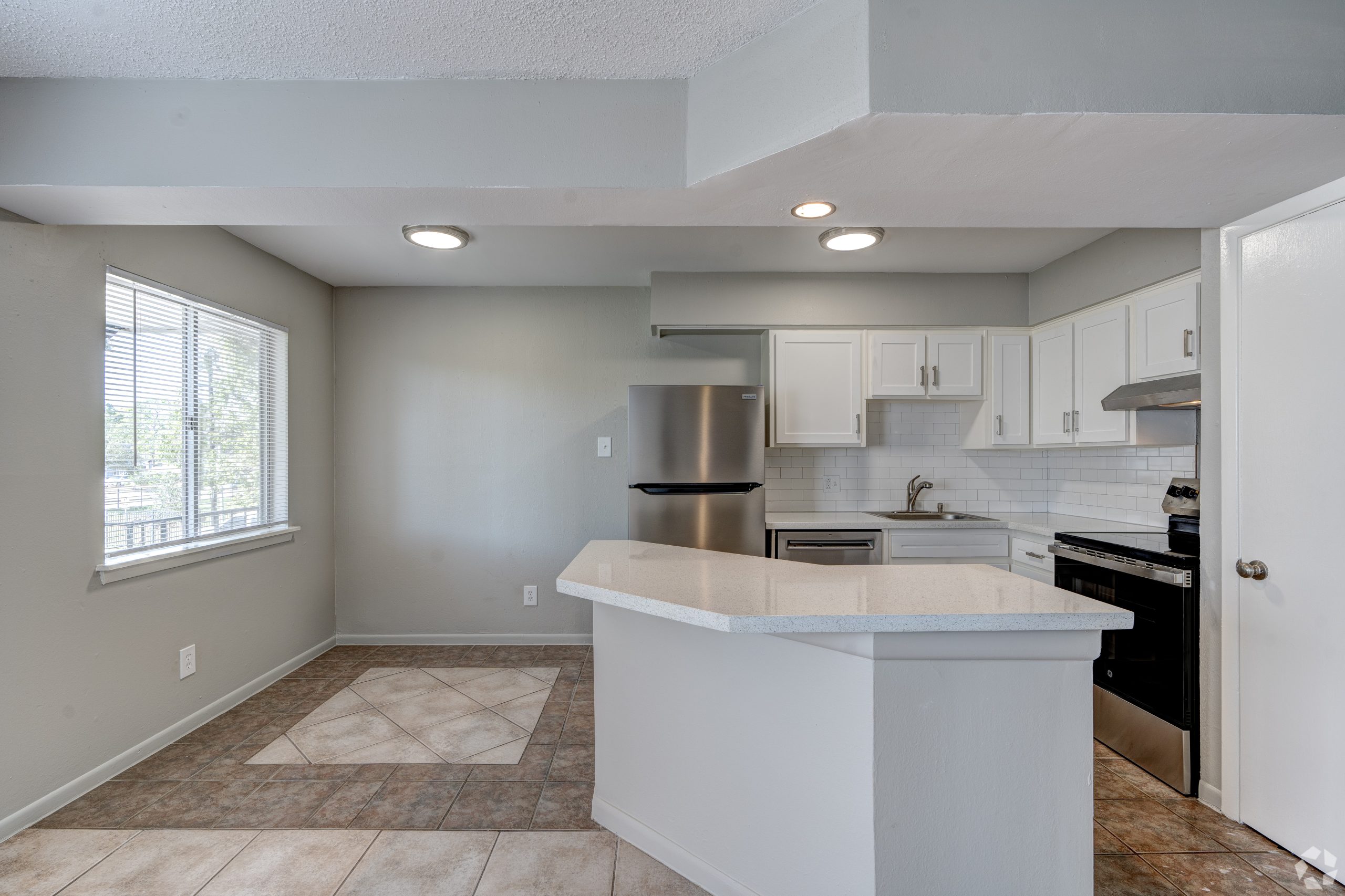 a kitchen with white cabinets and stainless steel appliances at The Westview Pines