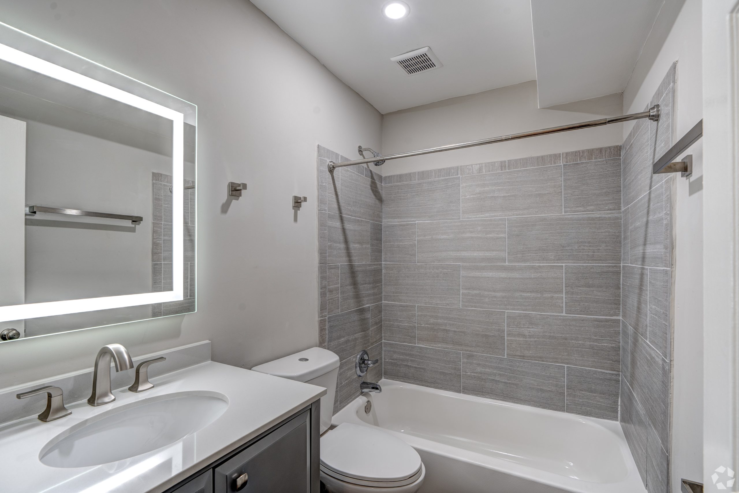 a bathroom with a tub and sink and a mirror at The Westview Pines